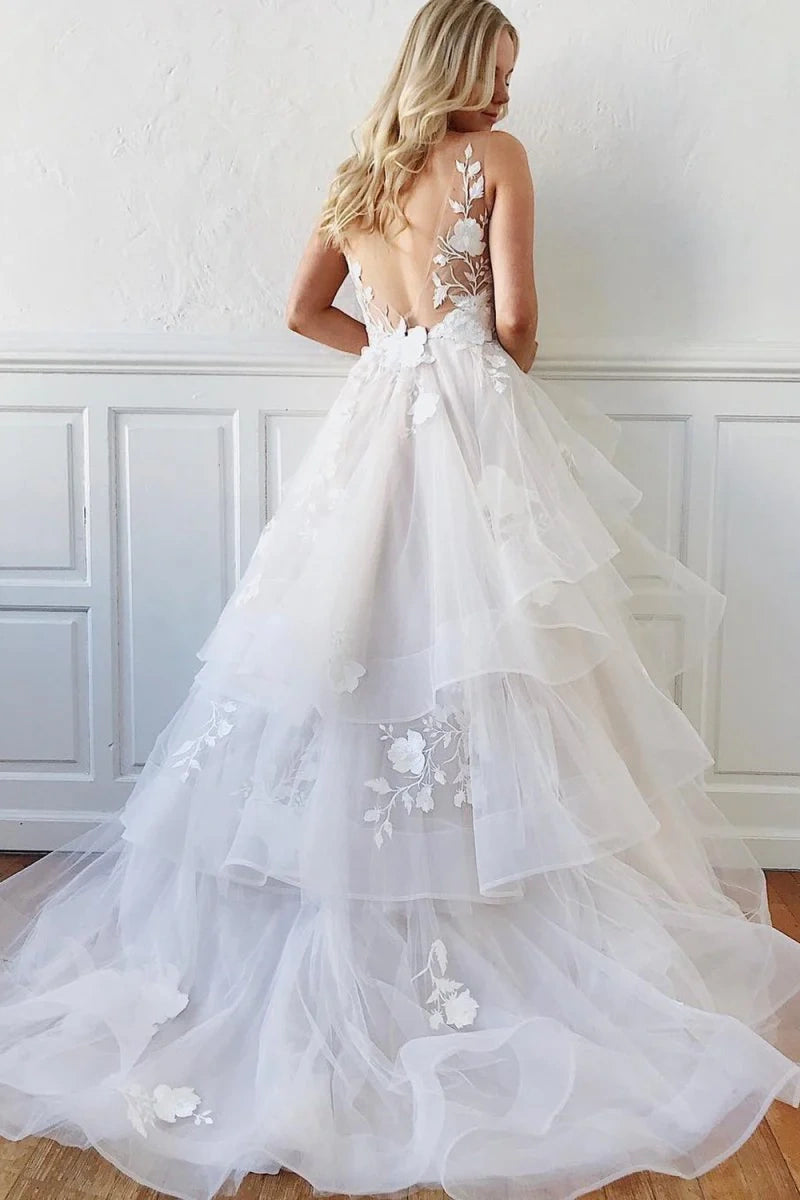 tiered a line wedding dress Tea-length A-line wedding dress with halter neck bodice and tiered skirt